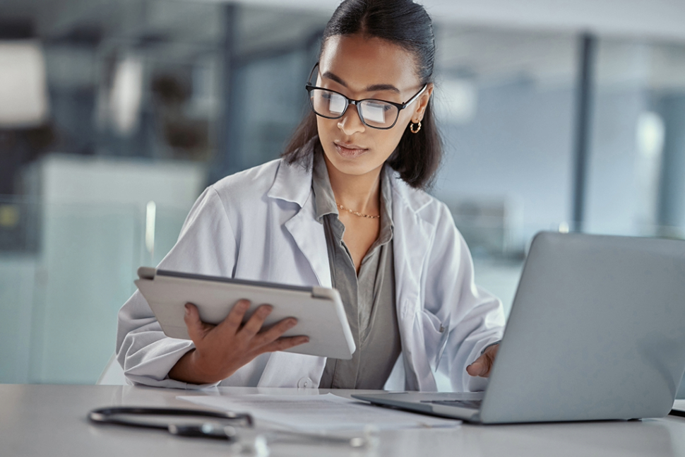 young female african american doctor using a digital tablet at work